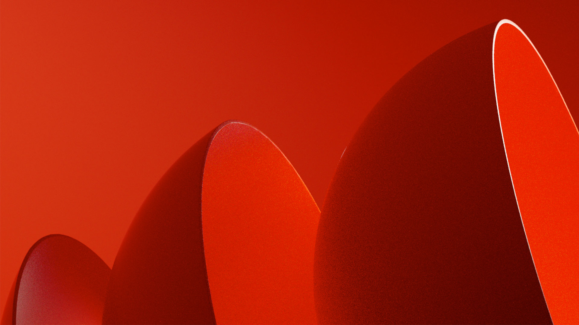 A bright red background with a trio of 3d half spheres lined up in ascending order.