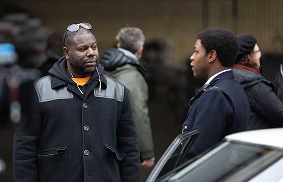 A photograph of director Steve McQueen and actor John Boyega on the set of 'Small Axe'.