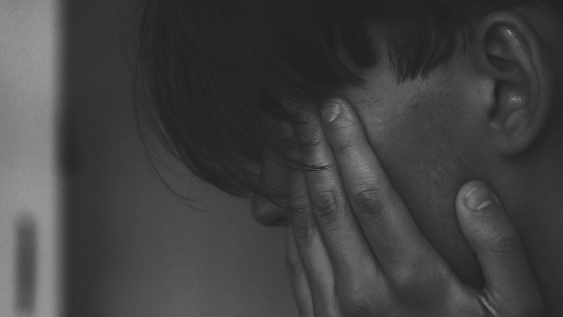 Black and white image of a person who is upset